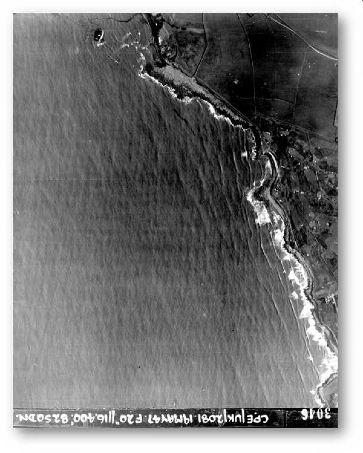 Aerial image No. 3046 taken on 19 May 1947 from the Royal Commission’s Royal Air Force Aerial Photography Collection shows the wreck of the Samtampa near the bottom right of the photograph.