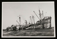 View of burnt-out wreckage of Seistan stern up in the water